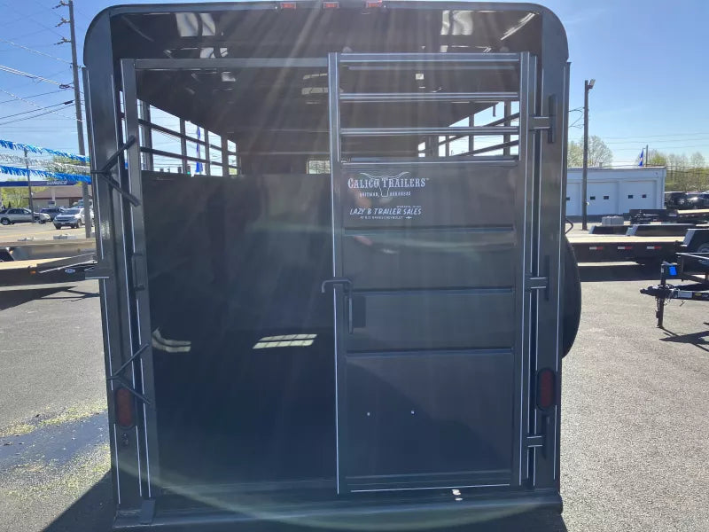 Interior of 16' Delco bumper-pull stock trailer showing center divider gate